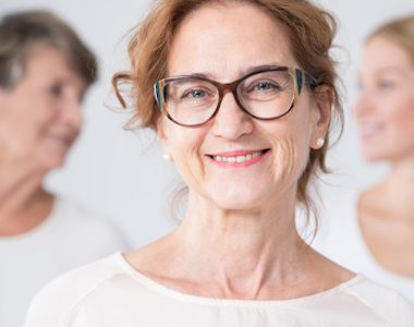Portrait of smiling mature woman in glasses with family
